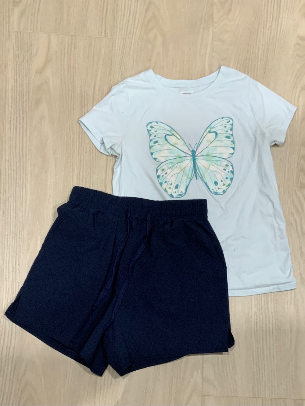 Athletic set. Kids Navy Blue Casual Shorts with light blue butterfly shirt.